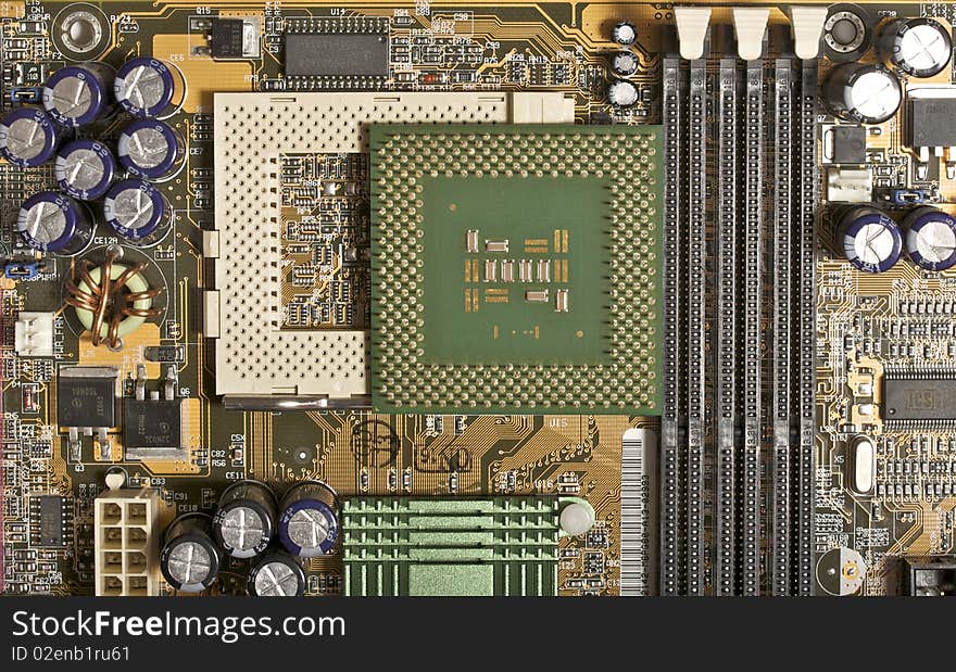 Computer motherboard cpu socket with CPU upside-down view with chips, capacitors, memory slots and chipset radiator view (front side top view). Computer motherboard cpu socket with CPU upside-down view with chips, capacitors, memory slots and chipset radiator view (front side top view)