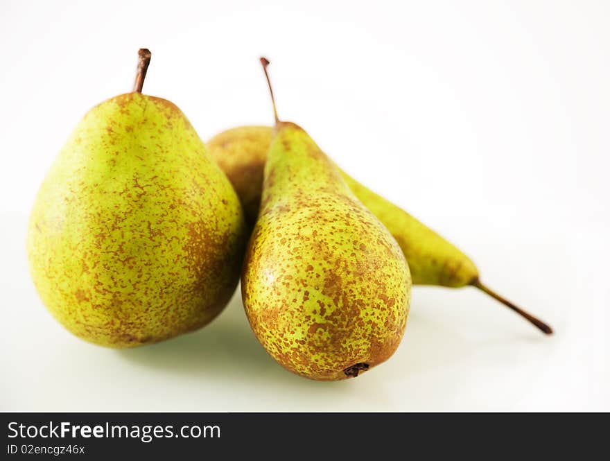 Three pears on a white background. Studio shot. Shallow depth of field. Three pears on a white background. Studio shot. Shallow depth of field.