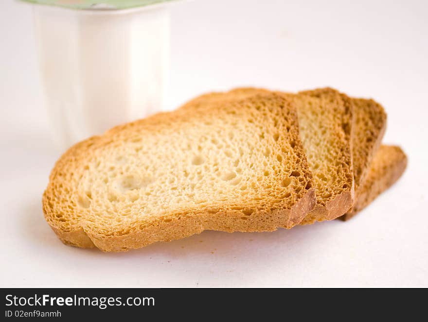 Dry bread with yogurt on a white background