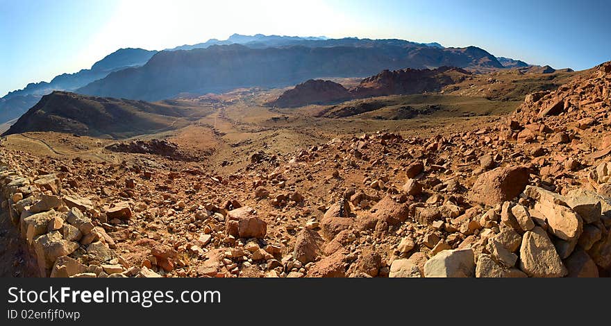 Stone desert with a mountain range in the distance