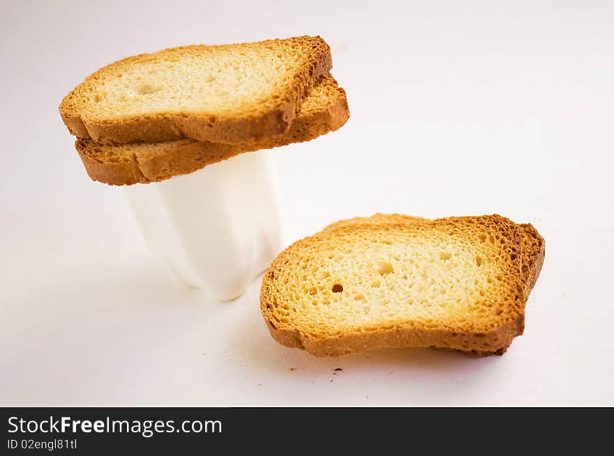 Dry bread with yogurt on a white background