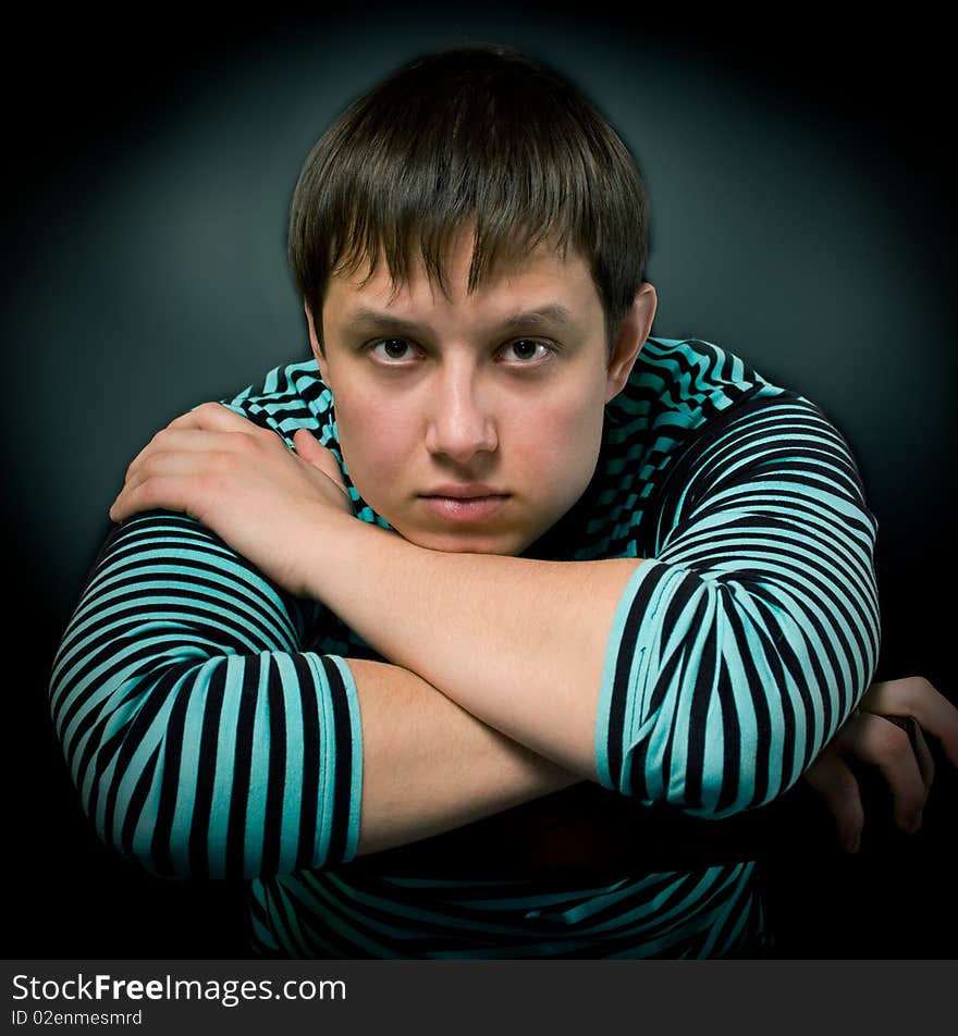 The young man sitting on a chair. The young man sitting on a chair