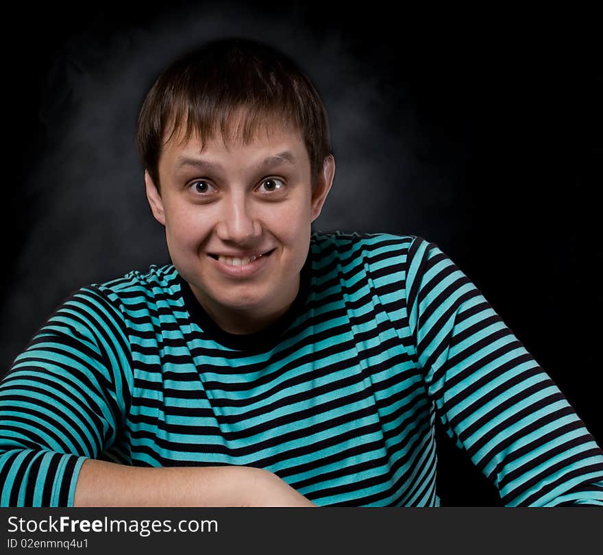 The young man sitting and looking at camera. The young man sitting and looking at camera