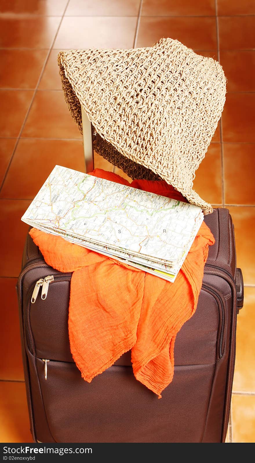 Travel with suitcase, map and sun hat