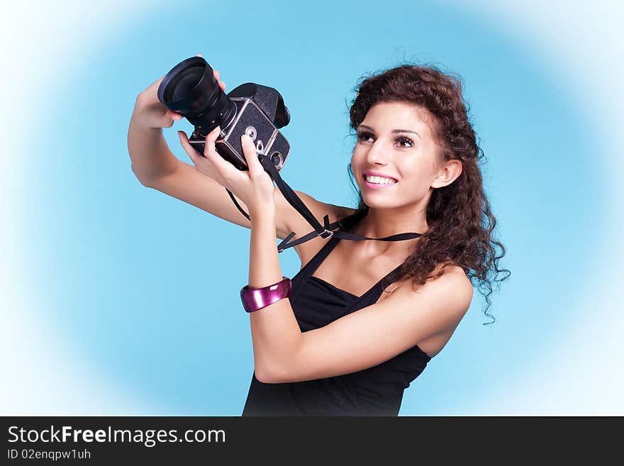 Girl photographer on blue background