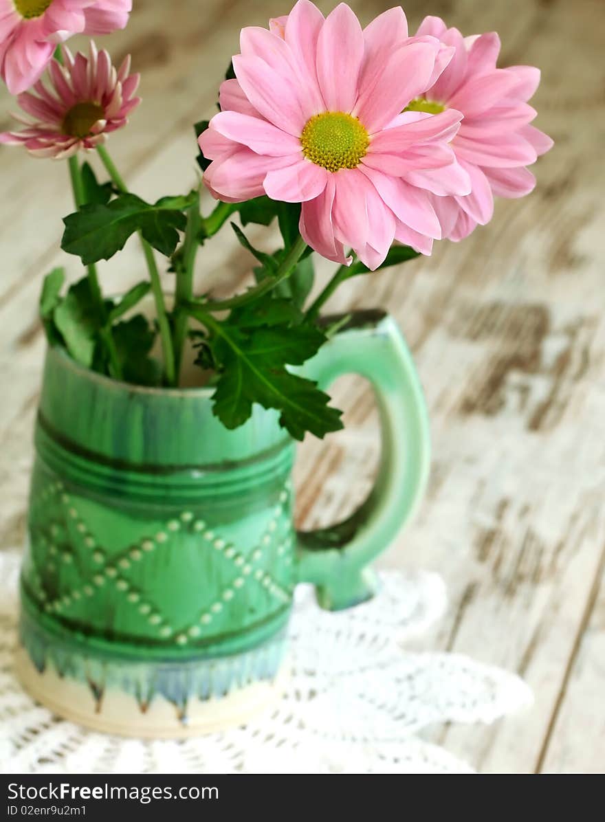 chrysanthemum in old ceramic mug