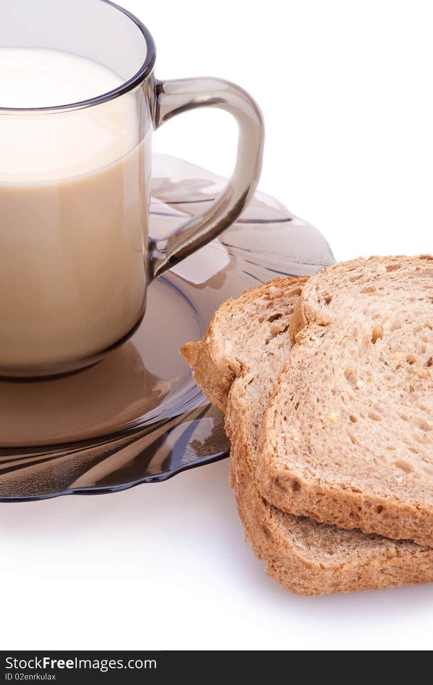 Bread and cup of milk on a white background