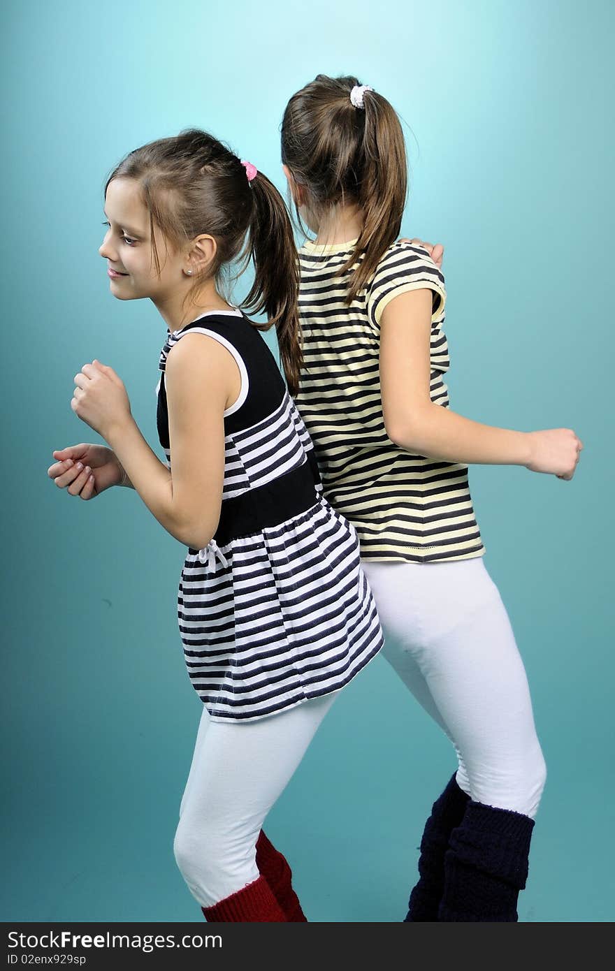 White twins having fun and dancing, turquoise background. White twins having fun and dancing, turquoise background