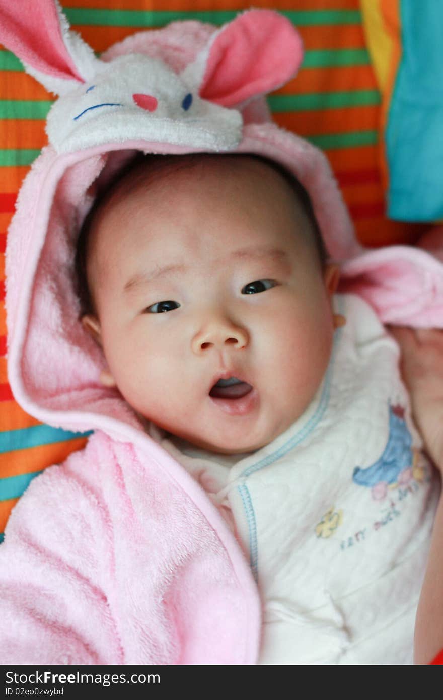 A yawning chinese baby with rabbit hat. A yawning chinese baby with rabbit hat