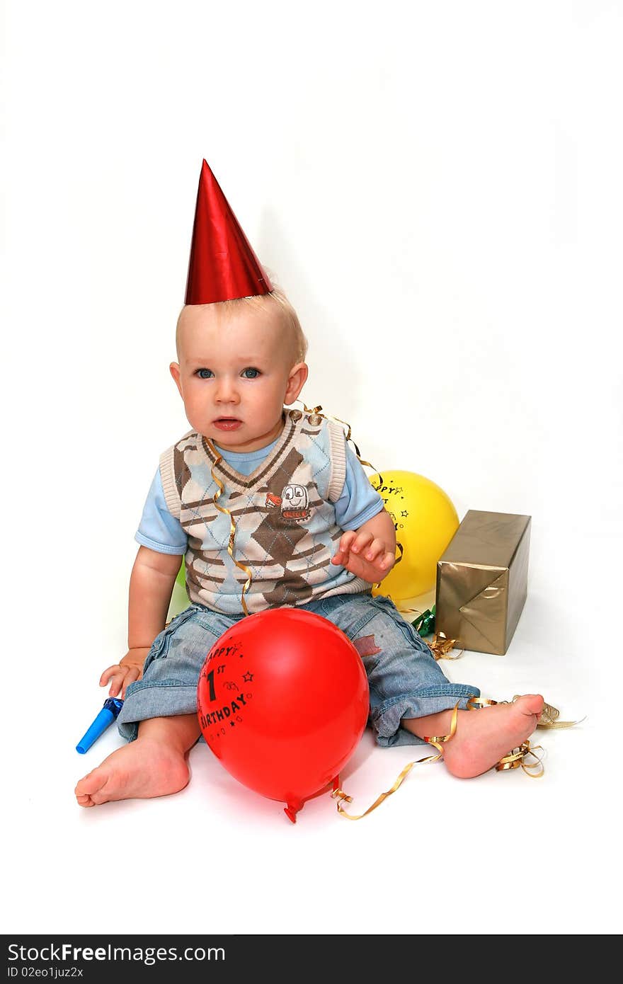 First birthday - happy baby boy with balloons on white background.