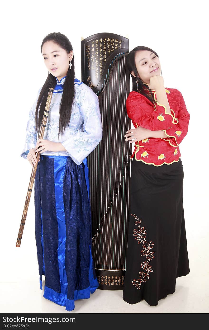 Two Chinese musicians with bamboo flute and zither on white.

Chinese characters on the flute means
wonderful voice,it is taken from one of China's ancient poetry.

Chinese character on zither is Chinese Tang poetry,also a famous Tang Dynasty poet's calligraphy. It praised the unique charm of the zither.