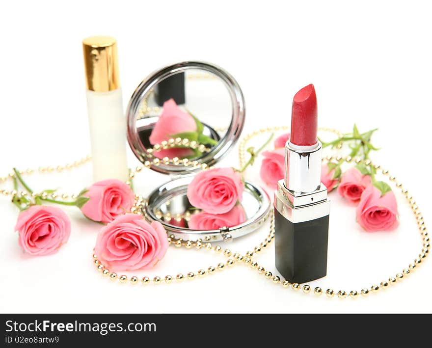 Decorative cosmetics and roses on a white background