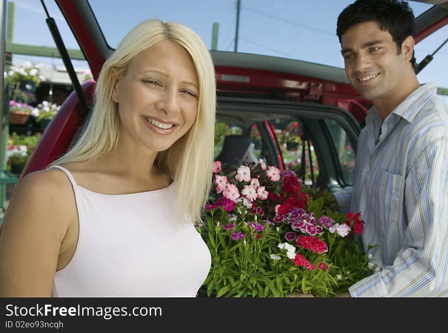 Couple Loading Plants Into Minivan, portrait