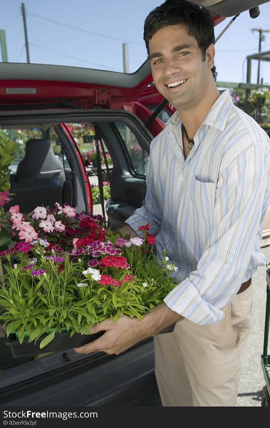 Man Loading Flowers into back of Van