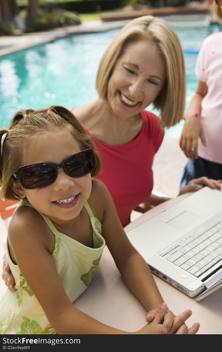 Two Girls Using Laptop With Grandmother