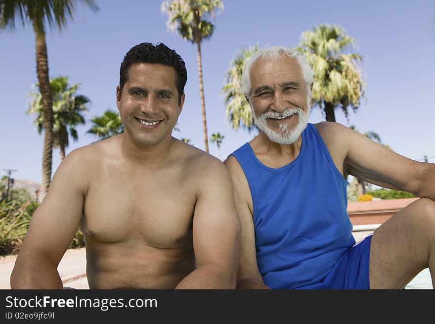 Senior Father And Son Sitting Outdoors.