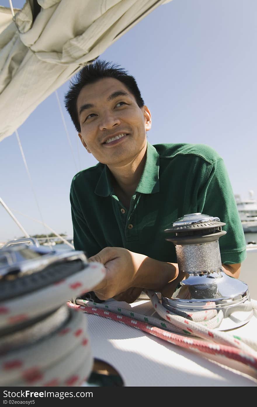 Asian ethnic Man on sailboat