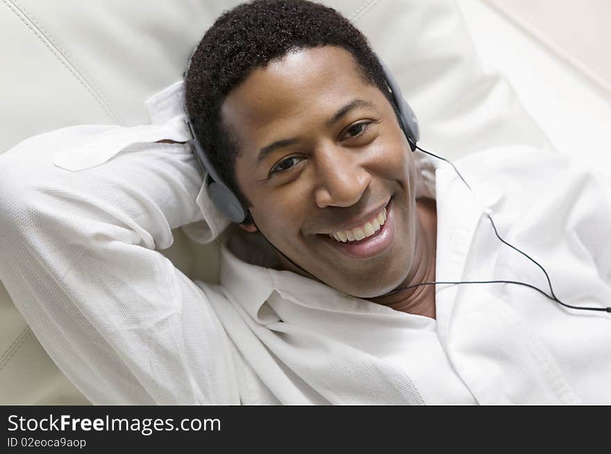 Man lying on sofa Listening to Music