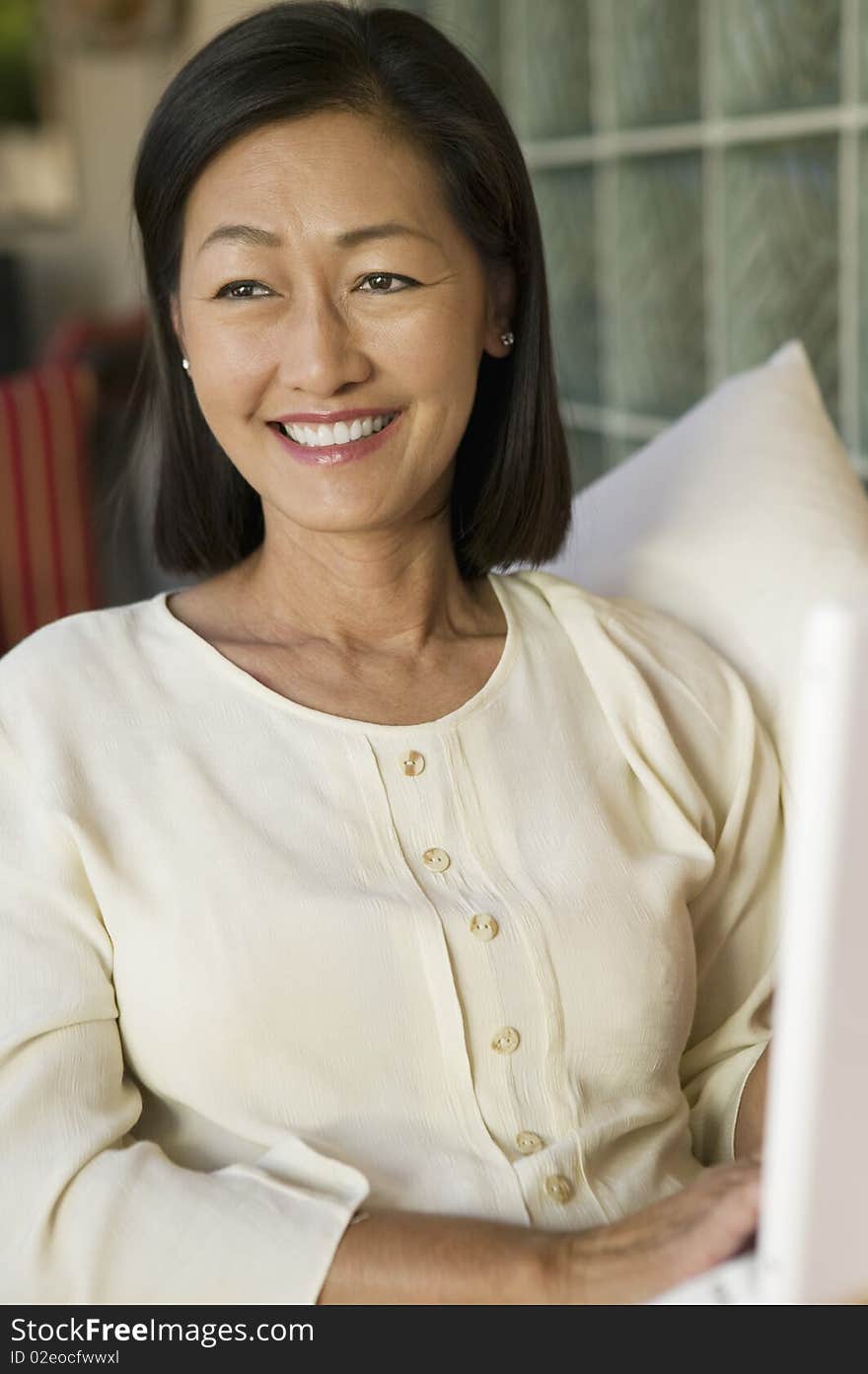 Woman Sitting on couch with laptop