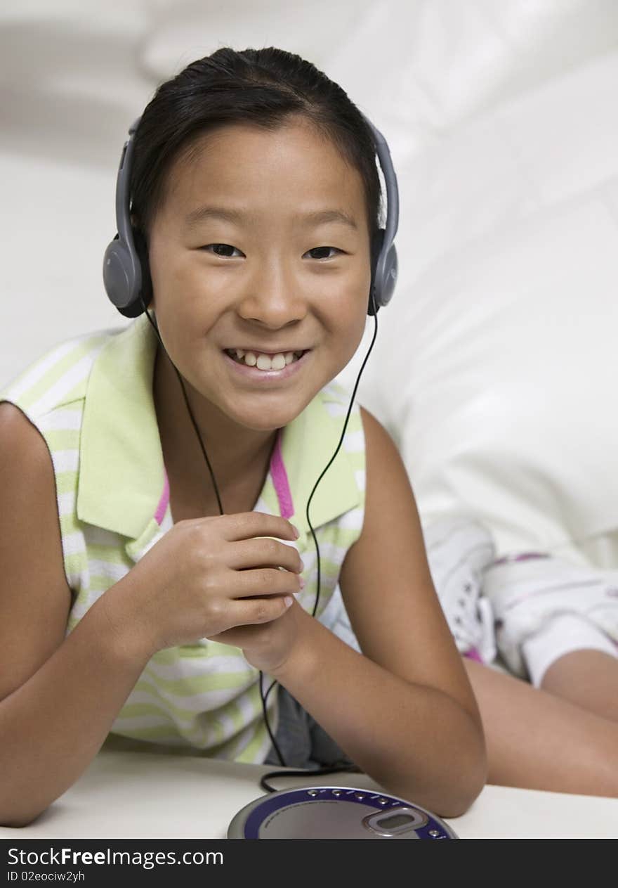 Young Girl on sofa Listening to portable CD player. Young Girl on sofa Listening to portable CD player