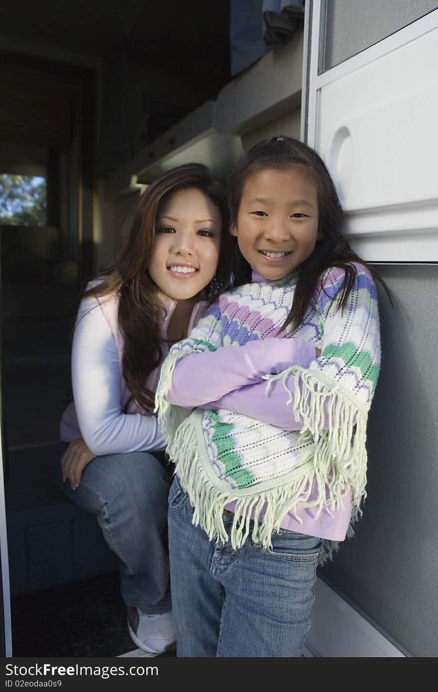 Sisters standing inside RV