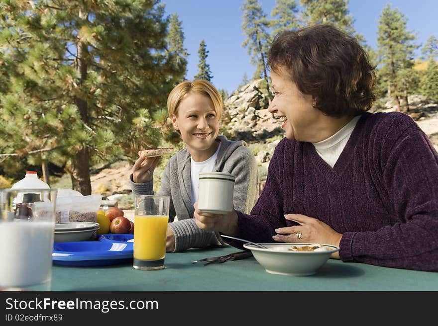 Women Eating At Picnic Table