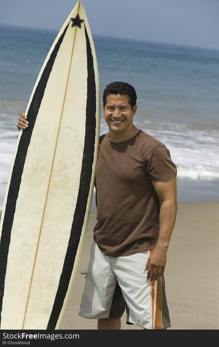 Man Holding Surfboard on beach
