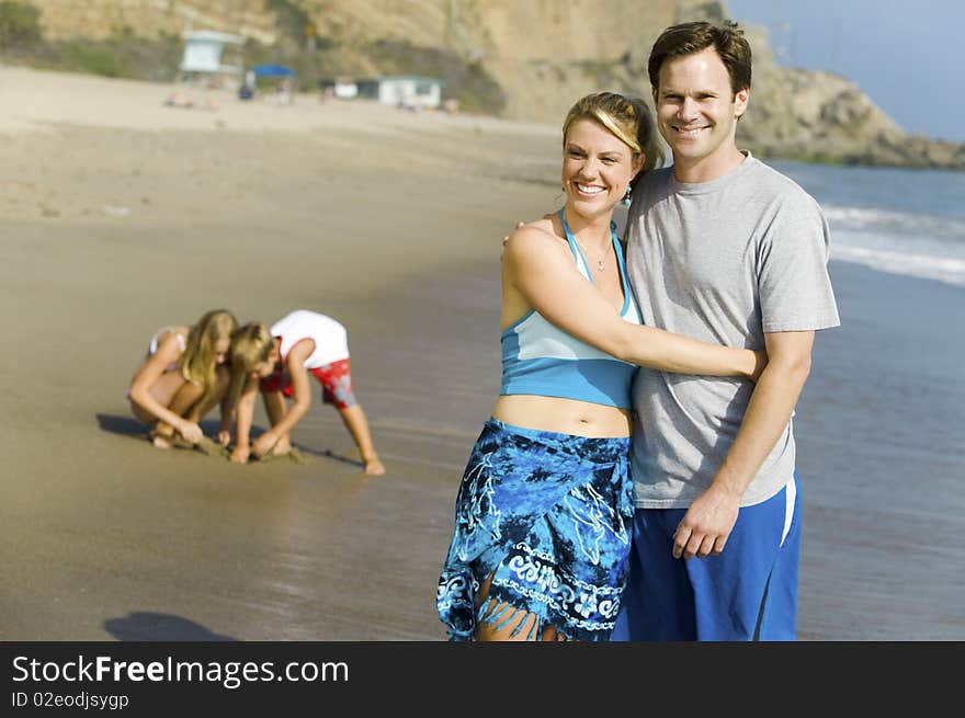 Couple with Family Enjoying relaxing on Beach. Couple with Family Enjoying relaxing on Beach