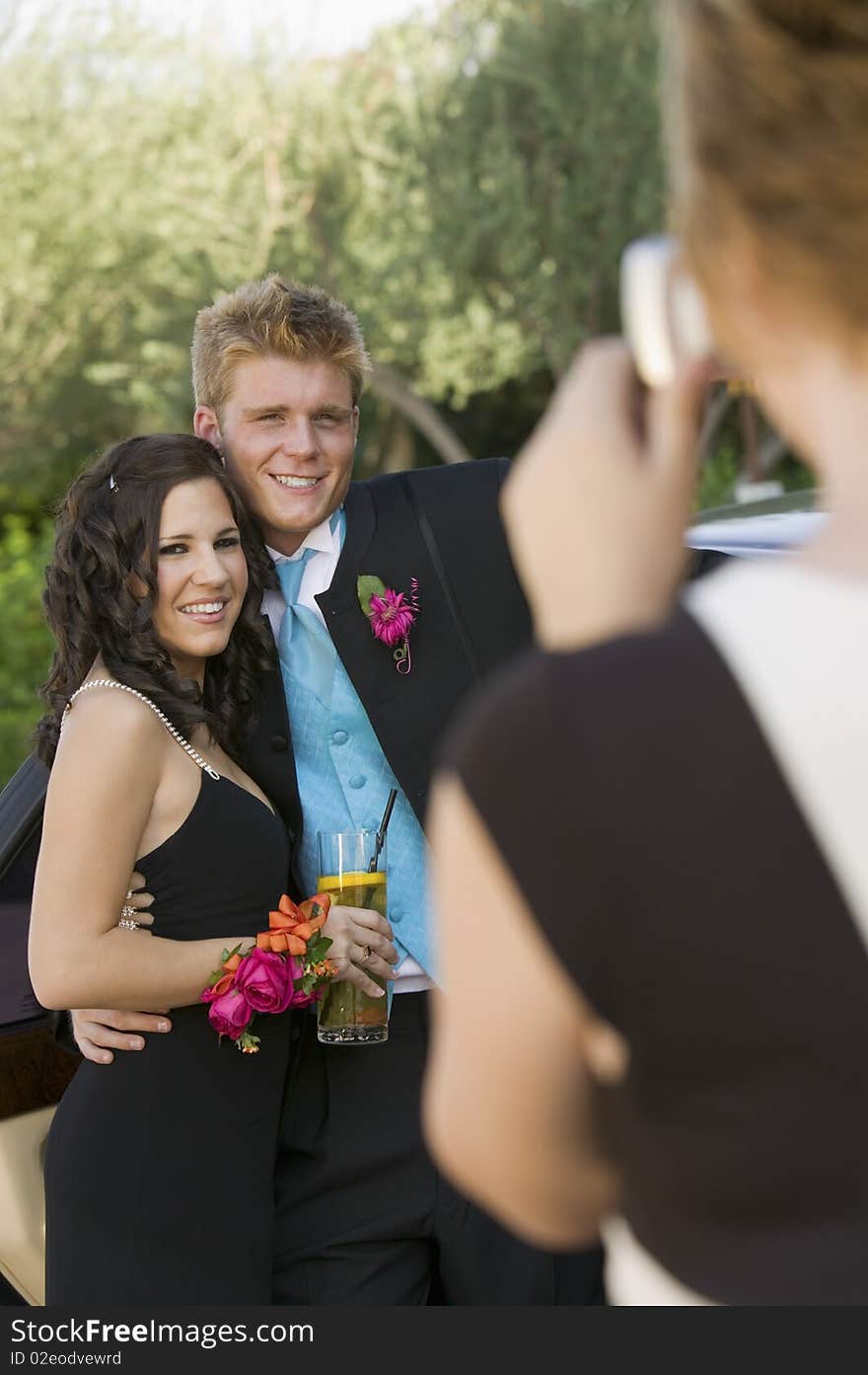 Well-dressed teenagers taking picture outside