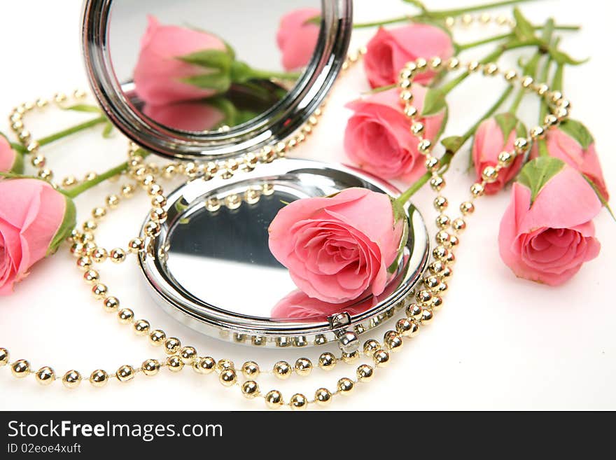 Rose and mirror on a white background