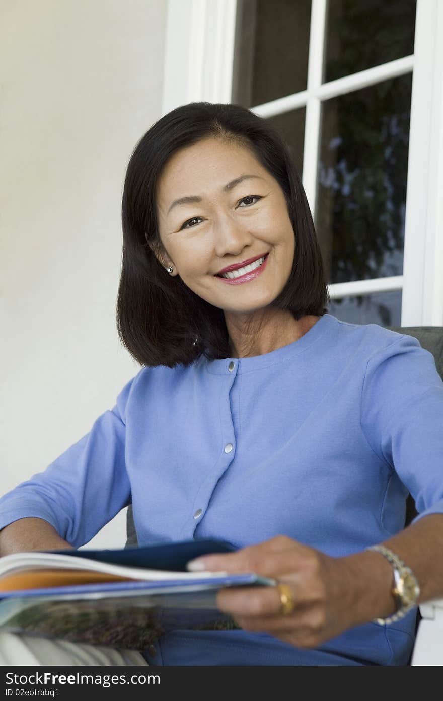 Woman Relaxing On Armchair Outdoors