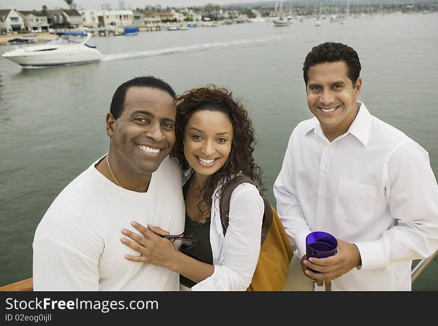 Couple with friend on yacht, (portrait), (elevated view)