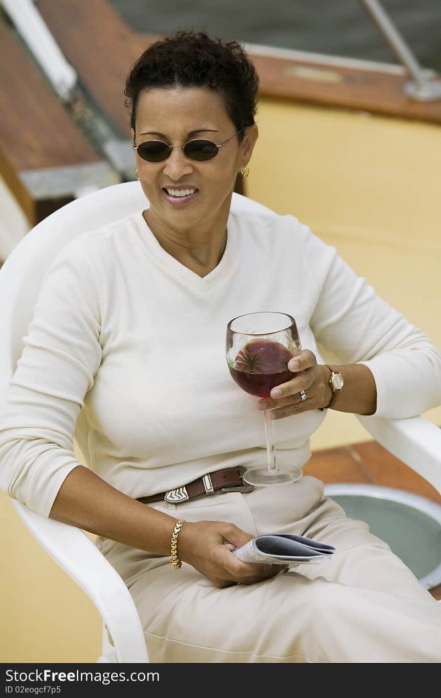 Woman Relaxing On Yacht, Holding Glass Of Wine