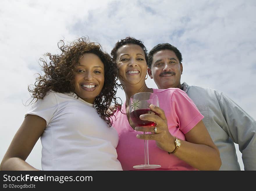 Couple with friend outdoors, (portrait), (low angle view)