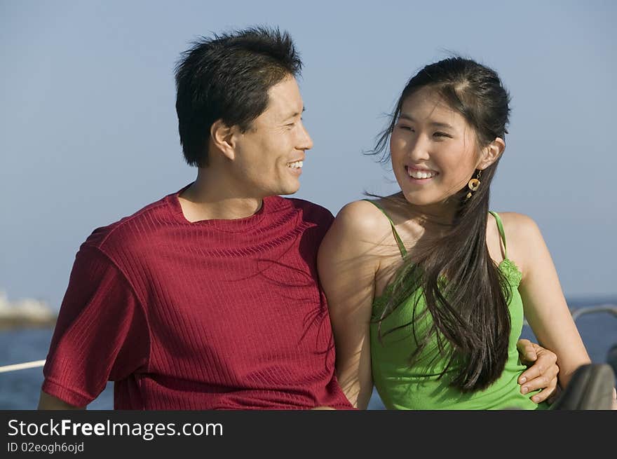 Asian ethnic Couple relaxing on boat