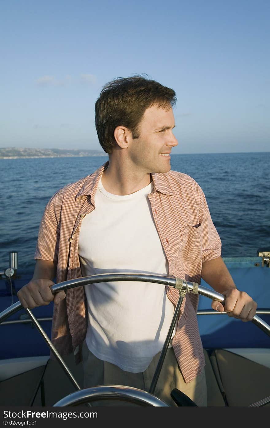 Man At Steering Of Sailboat