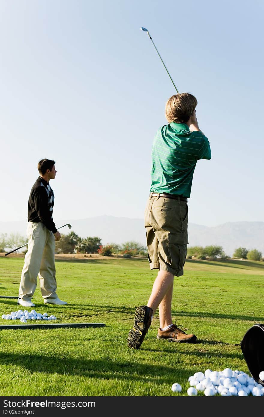 Two man practising golf