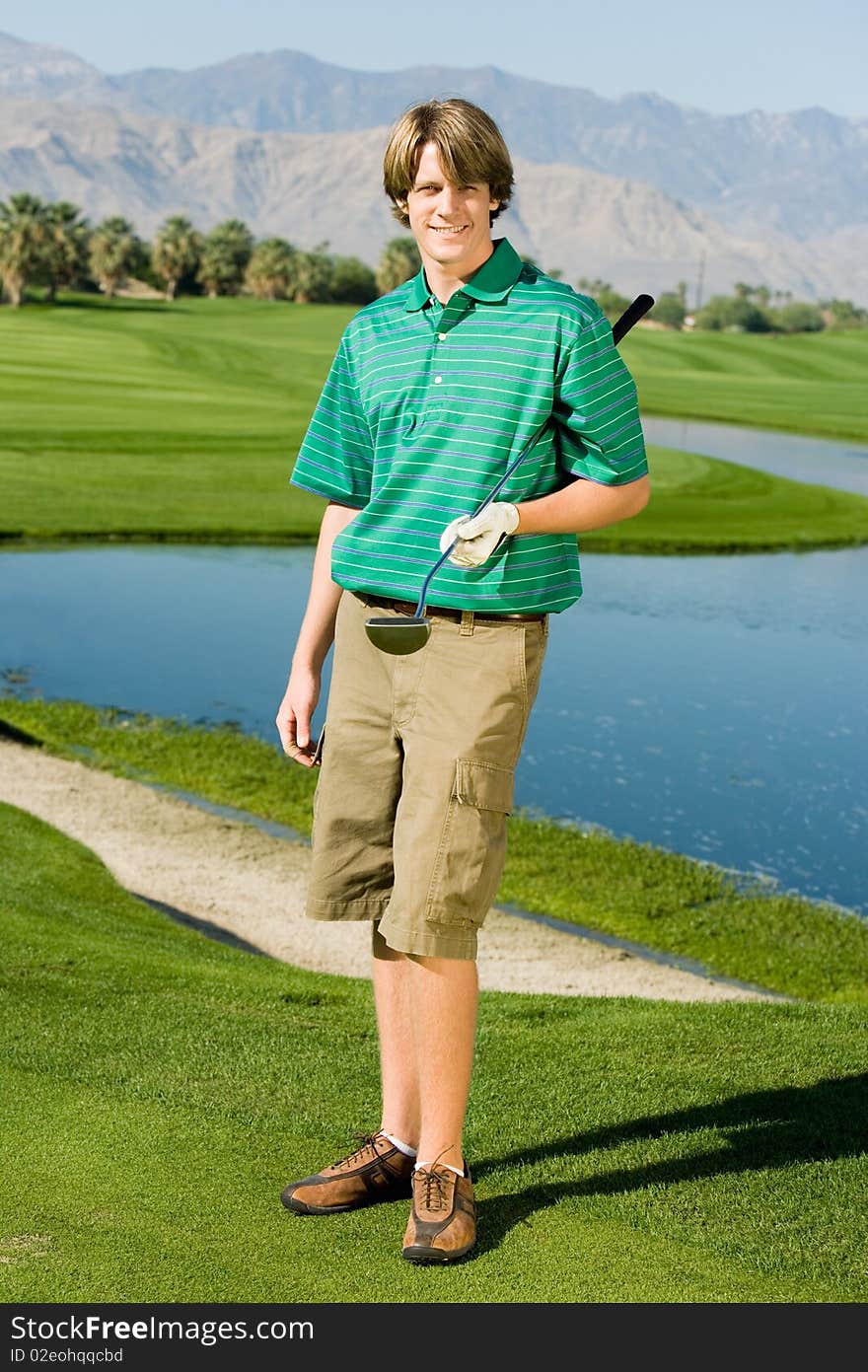 Golfer Standing On Golf Course Green