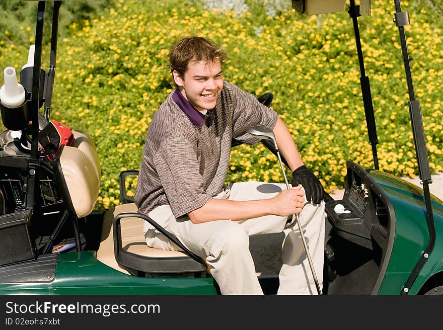 Golfer sitting in golf cart