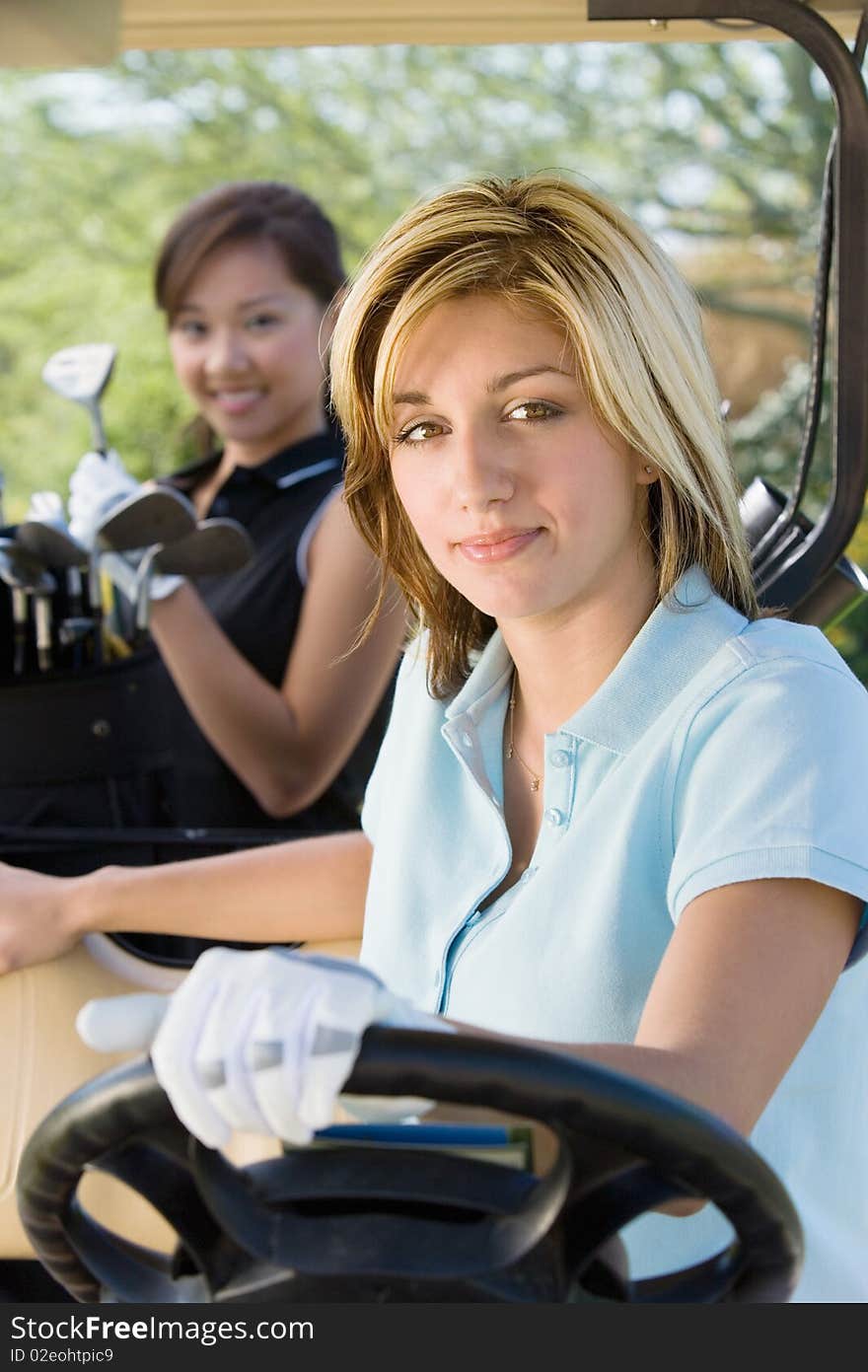 Two female golfers in golf cart