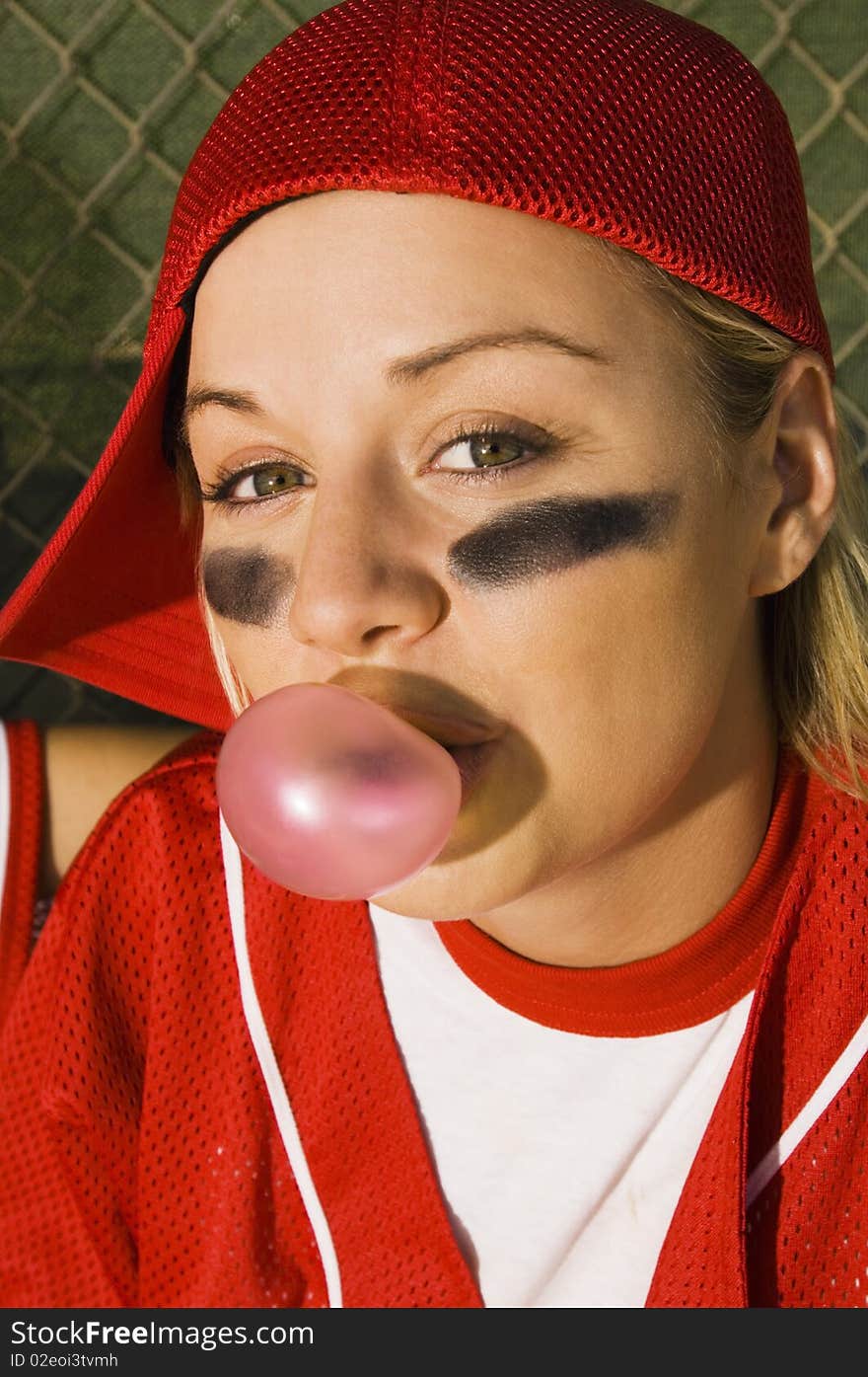 Softball player blowing bubblegum