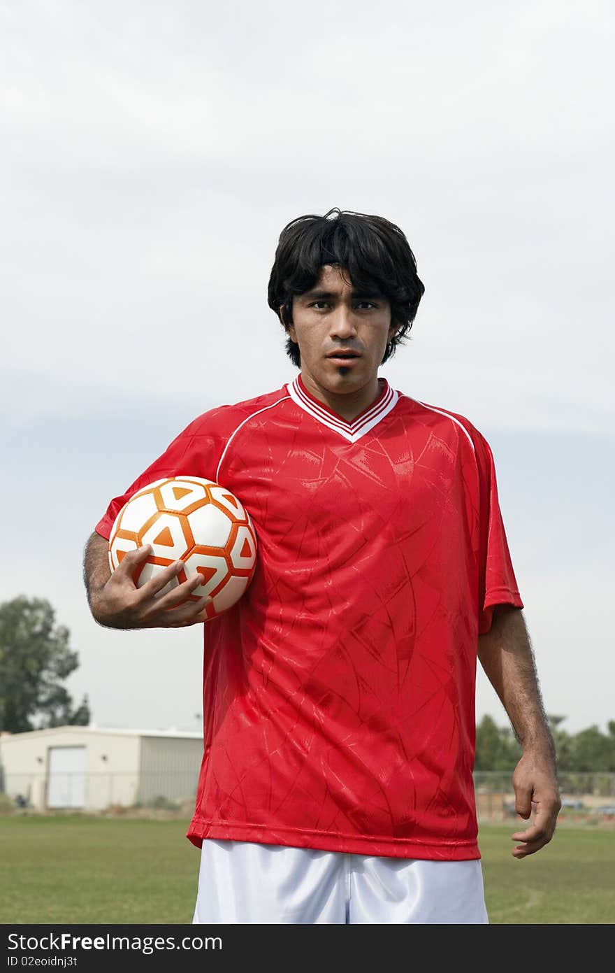 Soccer player holding ball