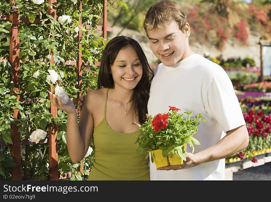 Young couple choosing potted flowers