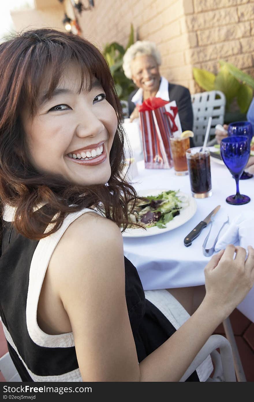 Smiling Woman sitting outdoors Having Lunch with friends. Smiling Woman sitting outdoors Having Lunch with friends