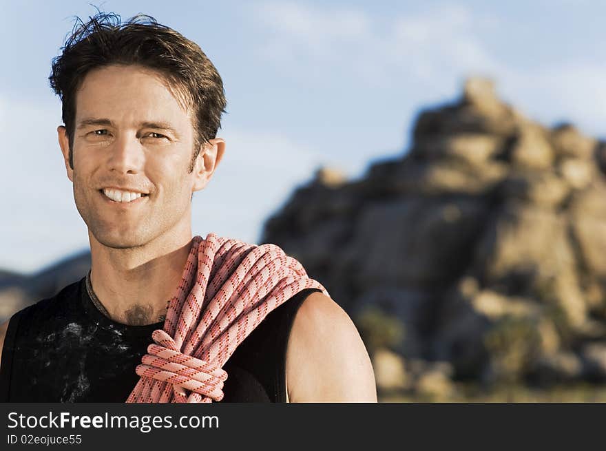 Male Rock climber with Rope on Shoulder,. Male Rock climber with Rope on Shoulder,