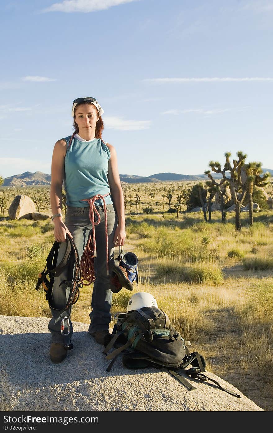 Climber standing on Boulder with Gear, (portrait)