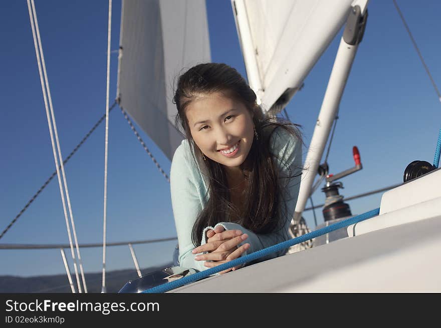 Young woman on sailboat, (portrait)