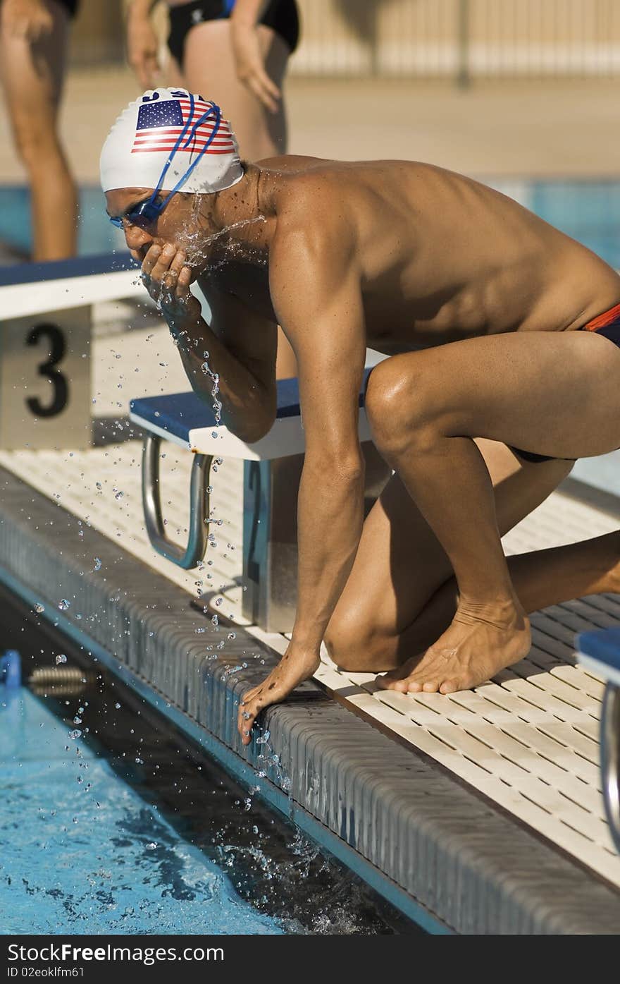 Swimmer Warming Up at Starting Blocks at outdoor pool