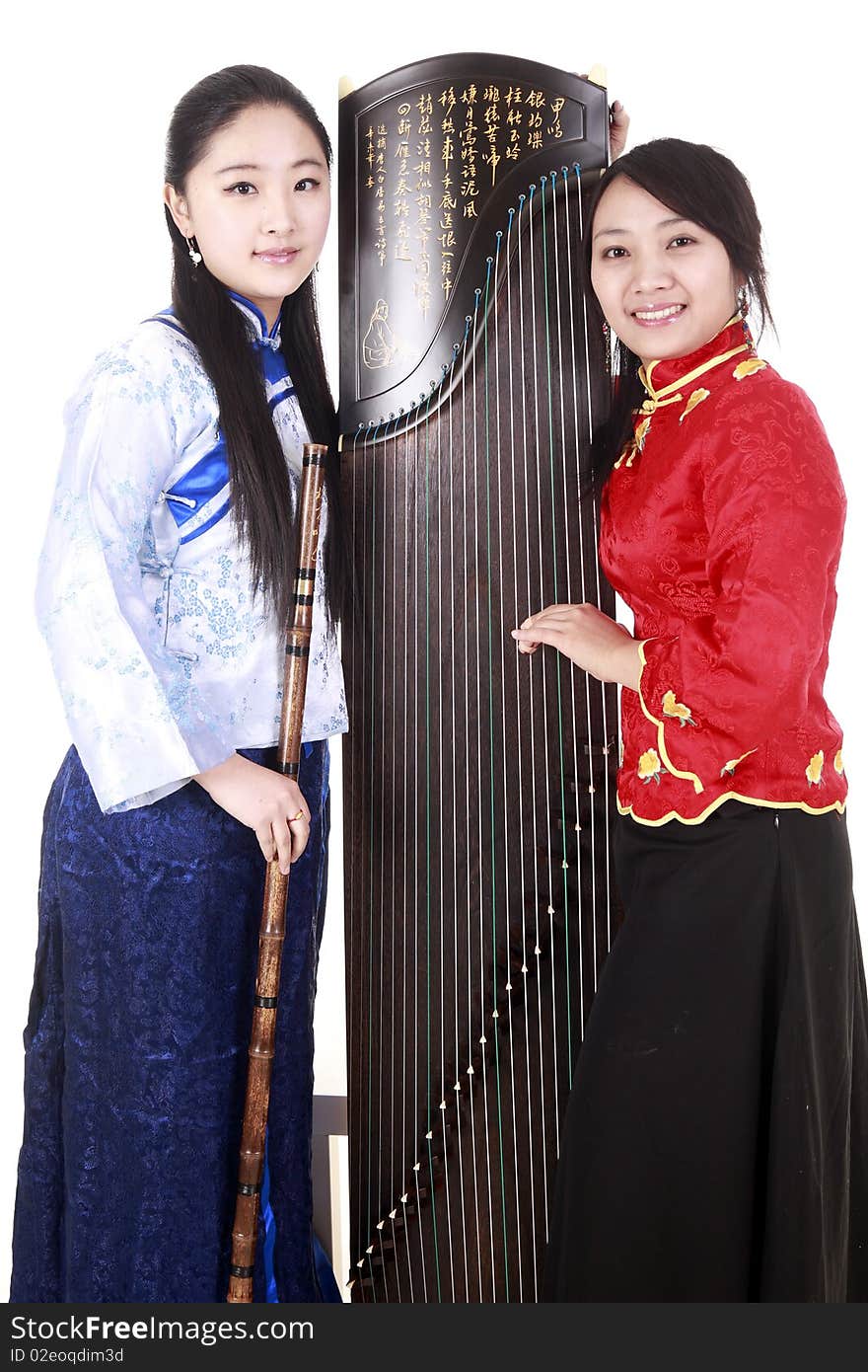 Two Chinese musicians with bamboo flute and zither on white. Chinese characters on the flute means wonderful voice,it is taken from one of China's ancient poetry. Chinese character on zither is Chinese Tang poetry,also a famous Tang Dynasty poet's calligraphy. It praised the unique charm of the zither. Two Chinese musicians with bamboo flute and zither on white. Chinese characters on the flute means wonderful voice,it is taken from one of China's ancient poetry. Chinese character on zither is Chinese Tang poetry,also a famous Tang Dynasty poet's calligraphy. It praised the unique charm of the zither.