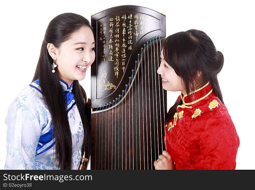 Two Chinese musicians with bamboo flute and zither talking on white. Chinese characters on the flute means wonderful voice,it is taken from one of China's ancient poetry. Chinese character on zither is Chinese Tang poetry,also a famous Tang Dynasty poet's calligraphy. It praised the unique charm of the zither.